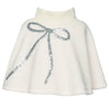 White knit sherpa poncho with a silver sequin bow on a white background