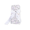 Floral-patterned swaddle wrap with a white ribbon 