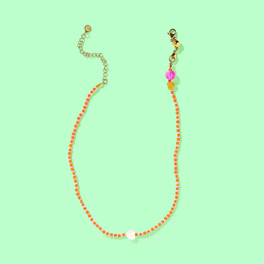 Necklace with colorful beads on a light green background