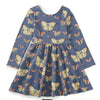 A long-sleeve children's dress in slate blue with an all-over butterfly print, featuring large cream, orange, and green butterflies. The dress has a round neckline, long sleeves, and a gathered empire waist with a flared skirt, shown flat on a white background.