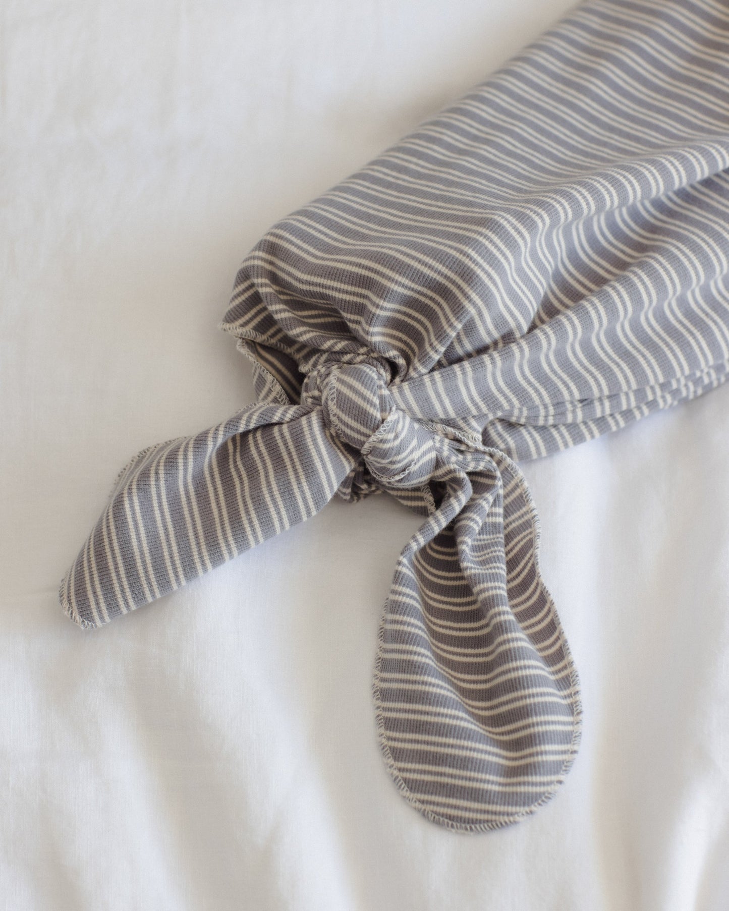 Slate Microstripe Gown + Hat, lifestyle photo of baby