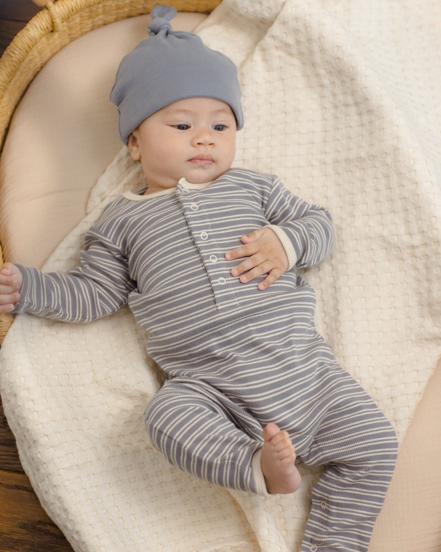 Baby wearing the Slate Microstripe Ribbed Romper, lifestyle photo