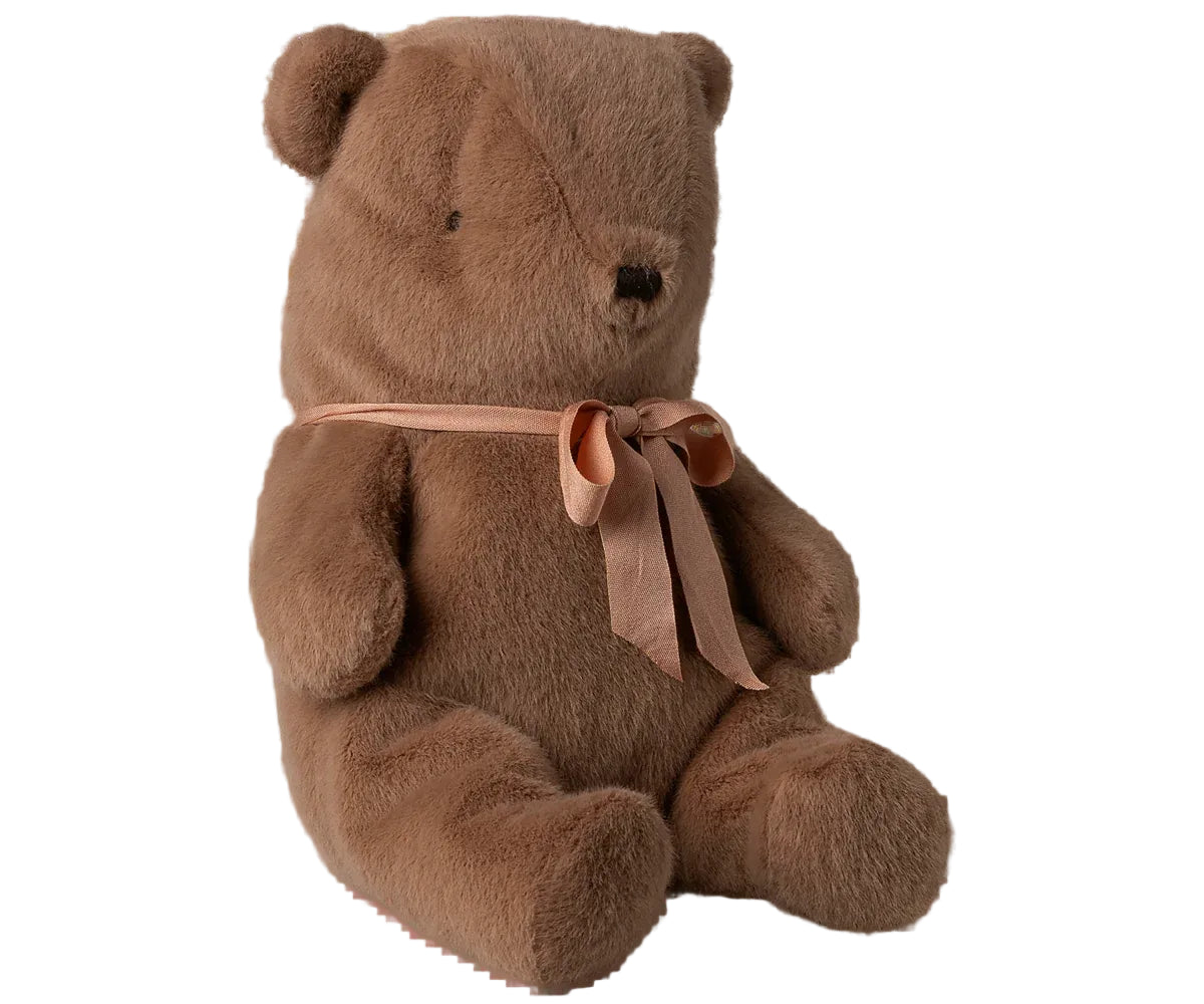 Brown teddy bear with a ribbon on a white background