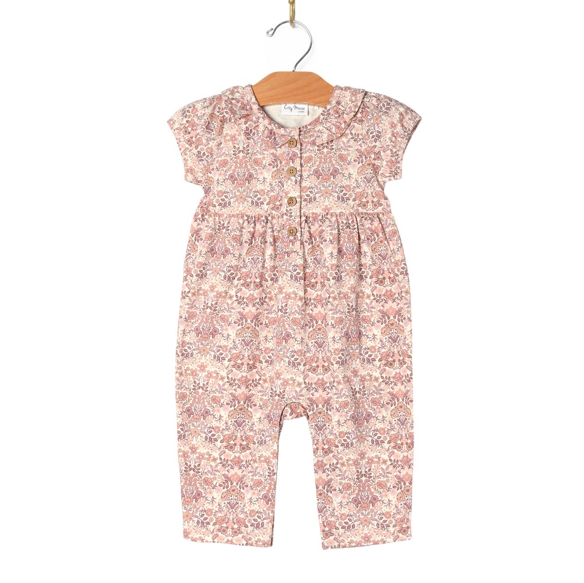 Floral-patterned baby romper on a hanger 