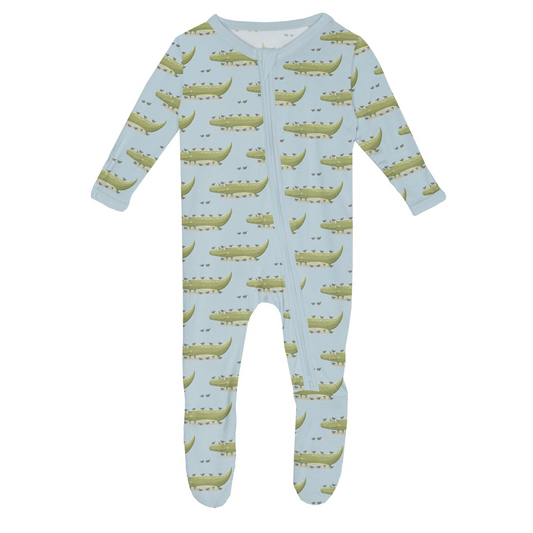 Baby footie with alligator pattern on a light blue background