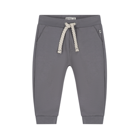 A pair of children's gray sweatpants with a patterned cream and gray drawstring, ribbed cuffs, and side pockets, shown against a plain white background.