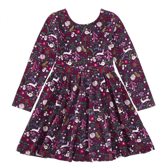 A long-sleeve children's dress with a dark purple and black base, covered in a whimsical floral and animal print featuring rabbits, flowers, and butterflies in pink, white, green, and yellow.
