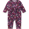 A baby long-sleeve romper with an all-over whimsical print of rabbits, flowers, and leaves in purple, pink, green, and white, shown flat on a white background.
