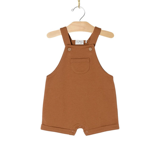 Brown children's overalls on a hanger 