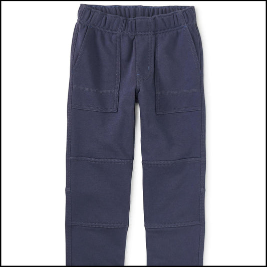 A pair of blue playwear pants for kids, featuring an elastic waistband, pockets, and reinforced knee areas.