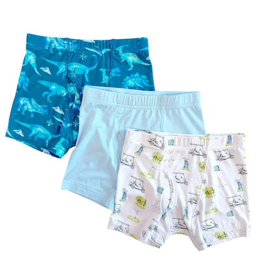 Three pairs of boys' underwear with different patterns on a white background