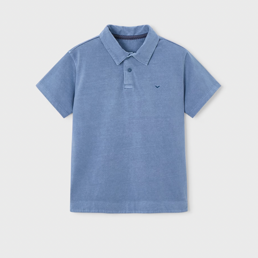 Blue polo shirt on a light gray background