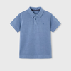 Blue polo shirt on a light gray background