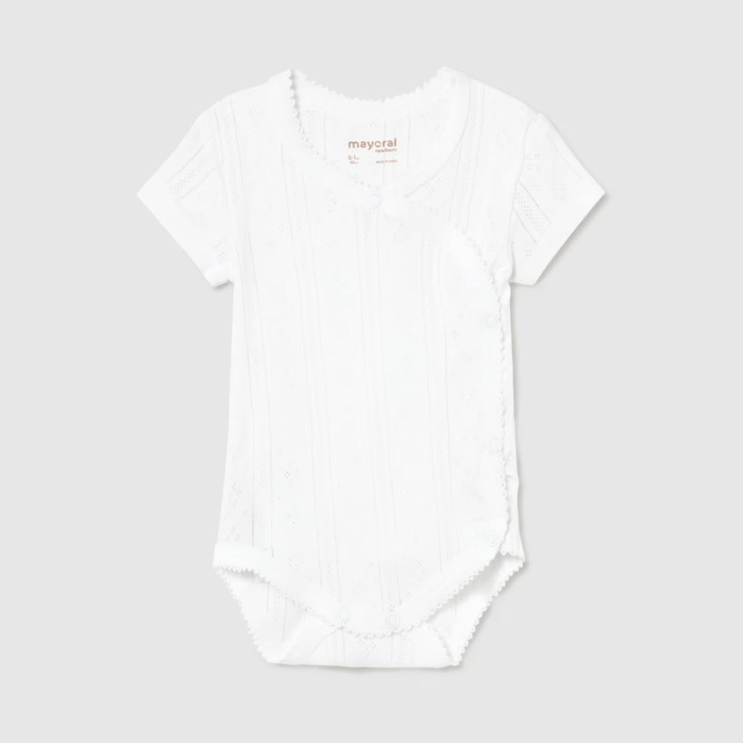 White pointelle bodysuit on a light gray background