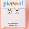 Dog-shaped earrings on a 'pierced' branded card with hypoallergenic information.