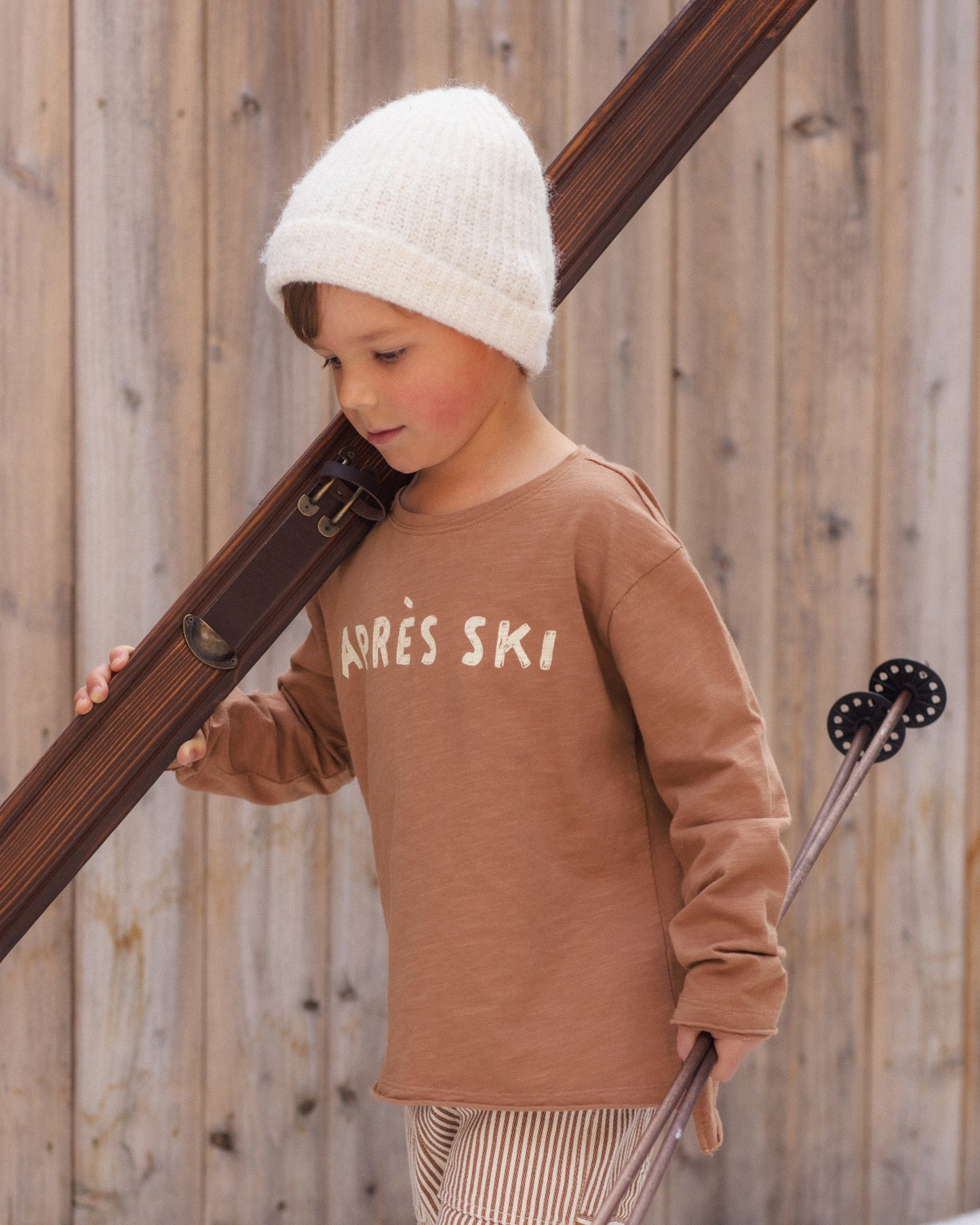 Child outdoors wearing the Apres Ski Raw Edge Top with the apres-ski print