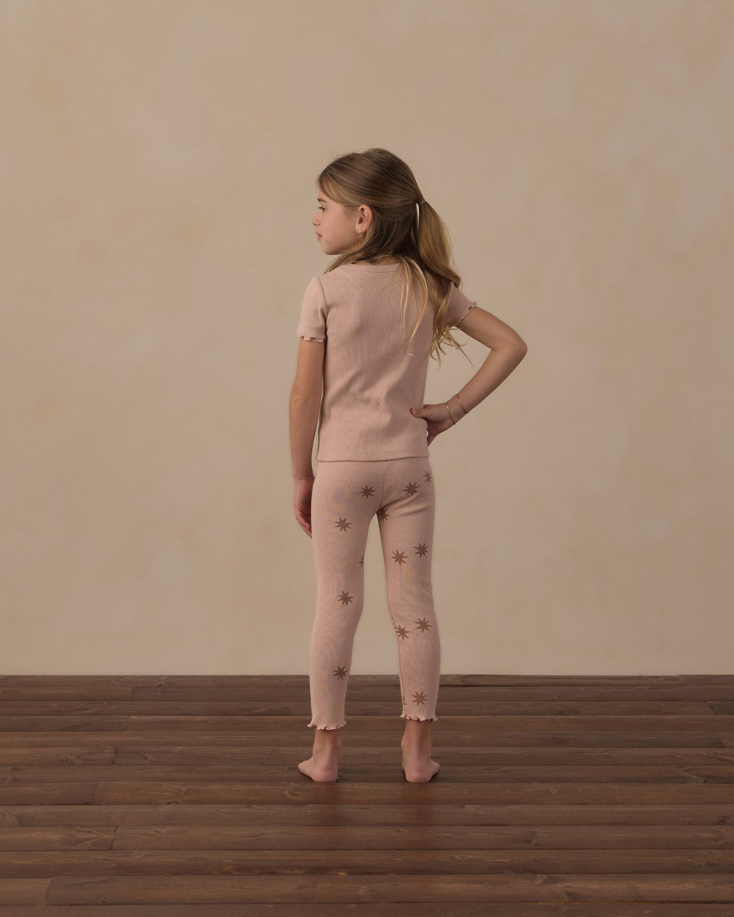 Close-up of lettuce-edge sleeve detail on the blush tee