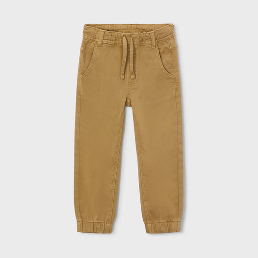 Tan jogger pants on a light beige background