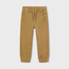 Tan jogger pants on a light beige background