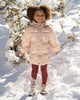 Child wearing the Brick Check leggings outdoors