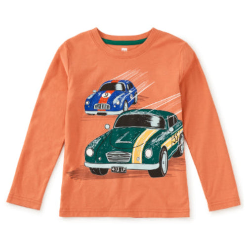 An orange long-sleeve crewneck t-shirt featuring a graphic print of two vintage racing cars, one green and one blue, on a white background.