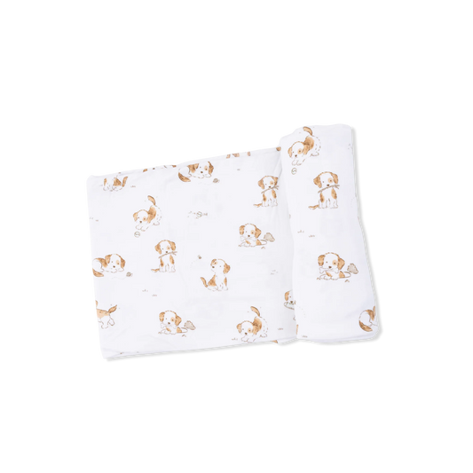 White swaddle with white and brown dog print