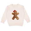 Beige sweater with a gingerbread man patch on a white background