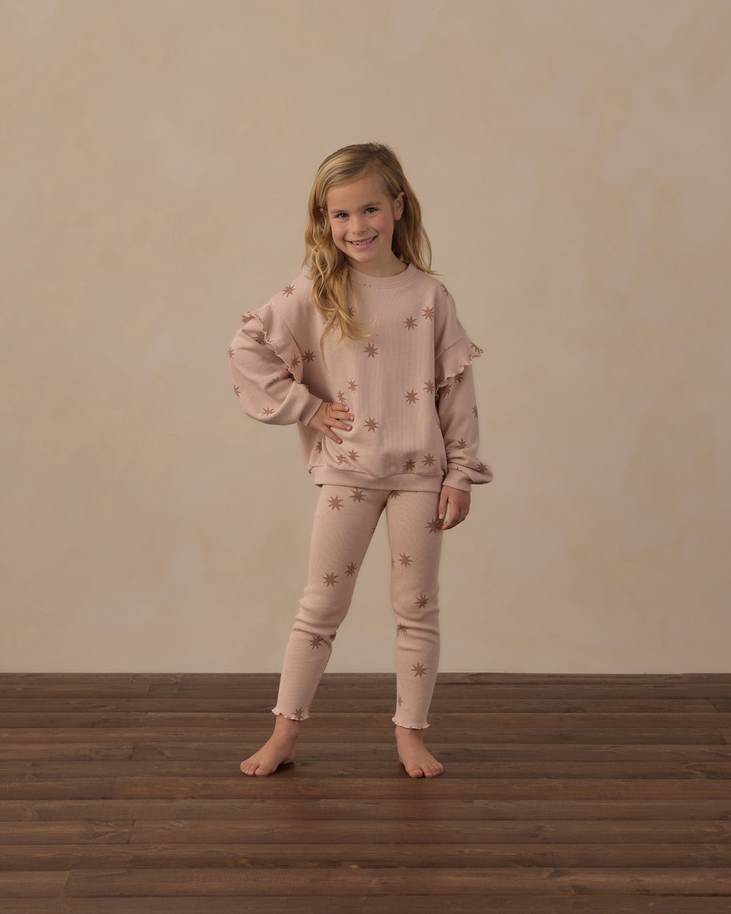 Child playing indoors in the Clay Stars Ribbed Leggings