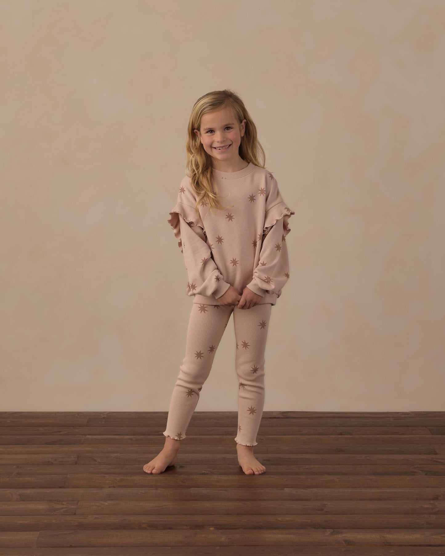 Girl standing in the blush Clay Stars Ribbed Leggings