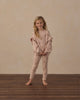 Girl standing in the blush Clay Stars Ribbed Leggings