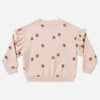 Girl wearing the Clay Stars Ruffle Sweatshirt with a ruffle sleeve detail