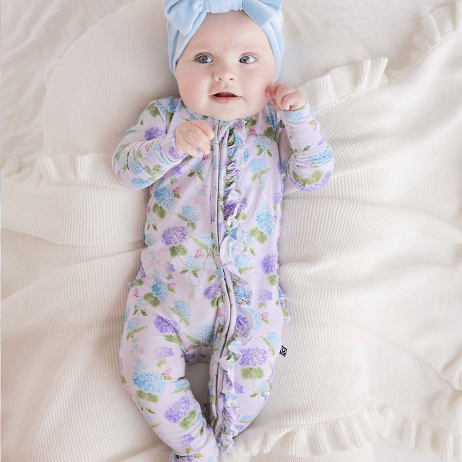Light purple ruffle zip footie with blue and purple hydrangea flower print