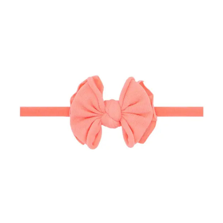 Coral-colored headband with a large bow 