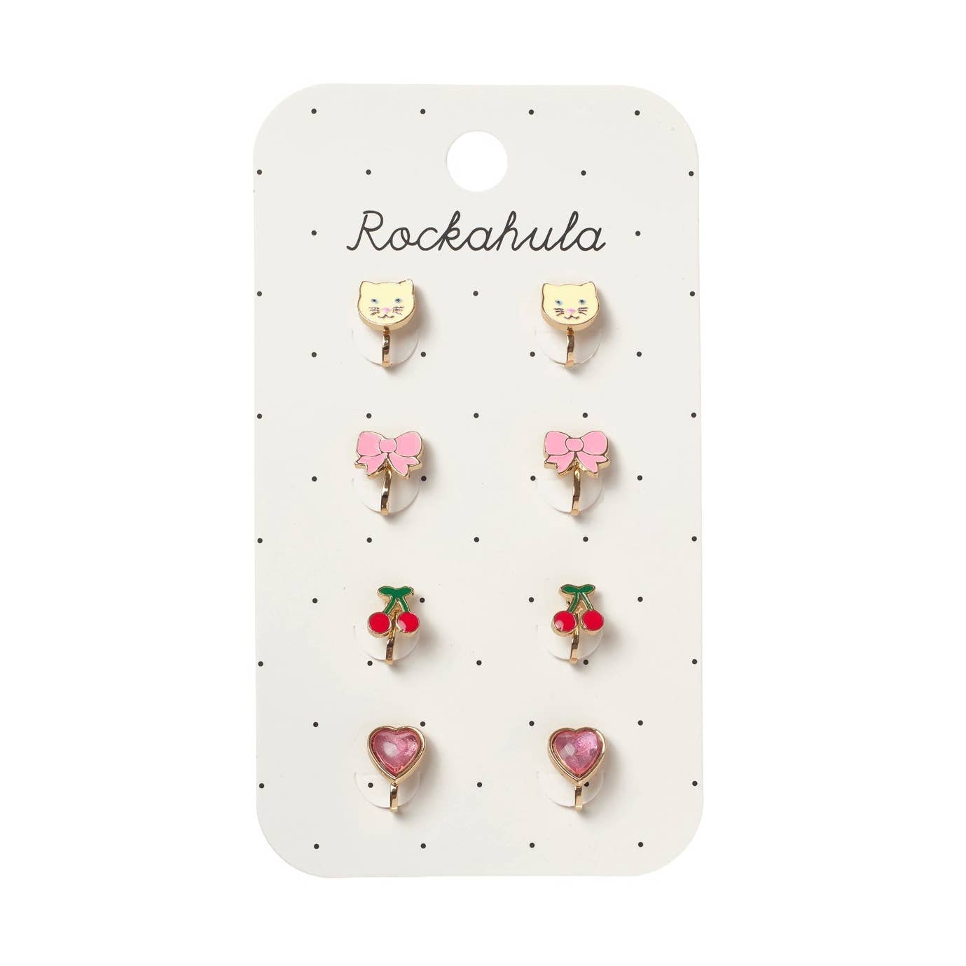 A set of six small stud earrings displayed on a white card labeled 'Rockahula'. The earrings include two yellow cat-face studs, two pink bow studs, two red cherry studs, and two pink heart studs, all with gold-tone metal settings.