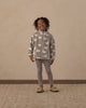 Baby in the dusty blue leggings outdoors