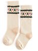 Pair of cream socks with festive pattern on a white background