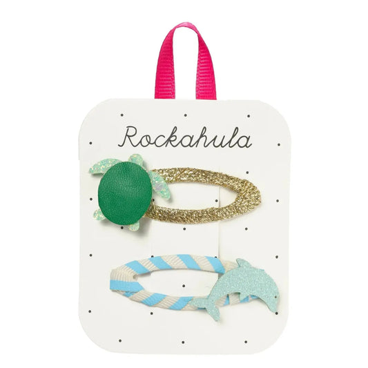 Set of hair accessories on a Rockahula branded card with a pink handle.