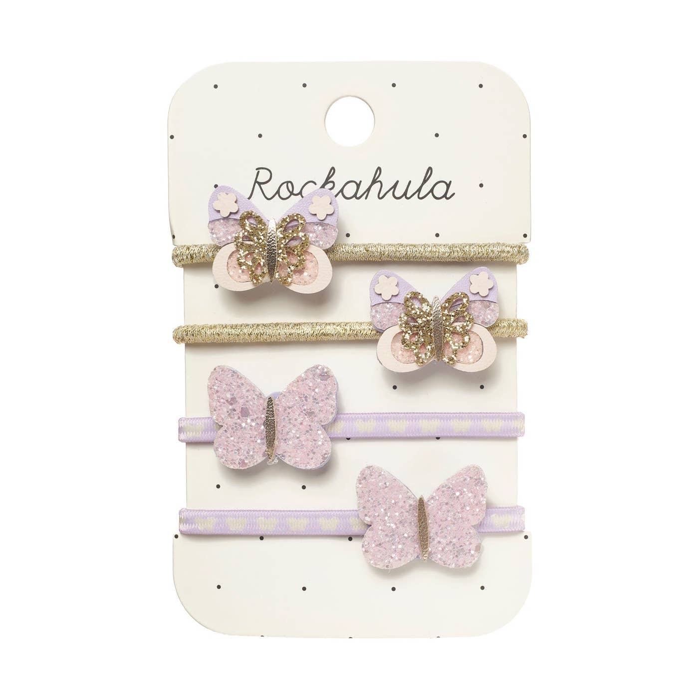 A set of four children's hair accessories on a white display card. The set includes two lavender and gold glitter butterfly hair clips, one lavender and gold glitter butterfly hair pin, and one lavender and white polka dot elastic hair tie, all attached to a white card printed with the brand name 'Rockahula'.
