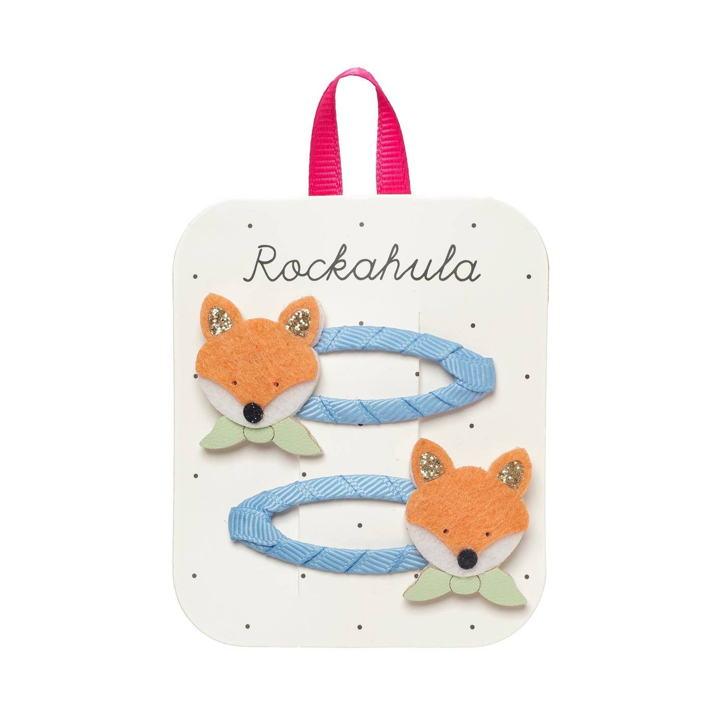 A set of two children's hair clips attached to a white display card. The clips are light blue with orange felt fox faces, white snouts, green bows, and glittery gold ear accents.