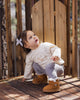 Child outdoors wearing the Fawn Luna Top over pants