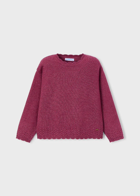 Maroon sweater on a light gray background