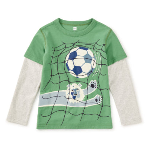 A kids' long-sleeve t-shirt featuring a green body and heather gray sleeves, with a soccer-themed graphic of a ball in a net and a goalie on a white background.