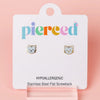 Cat-shaped earrings on a 'pierceed' branded card with a pink background