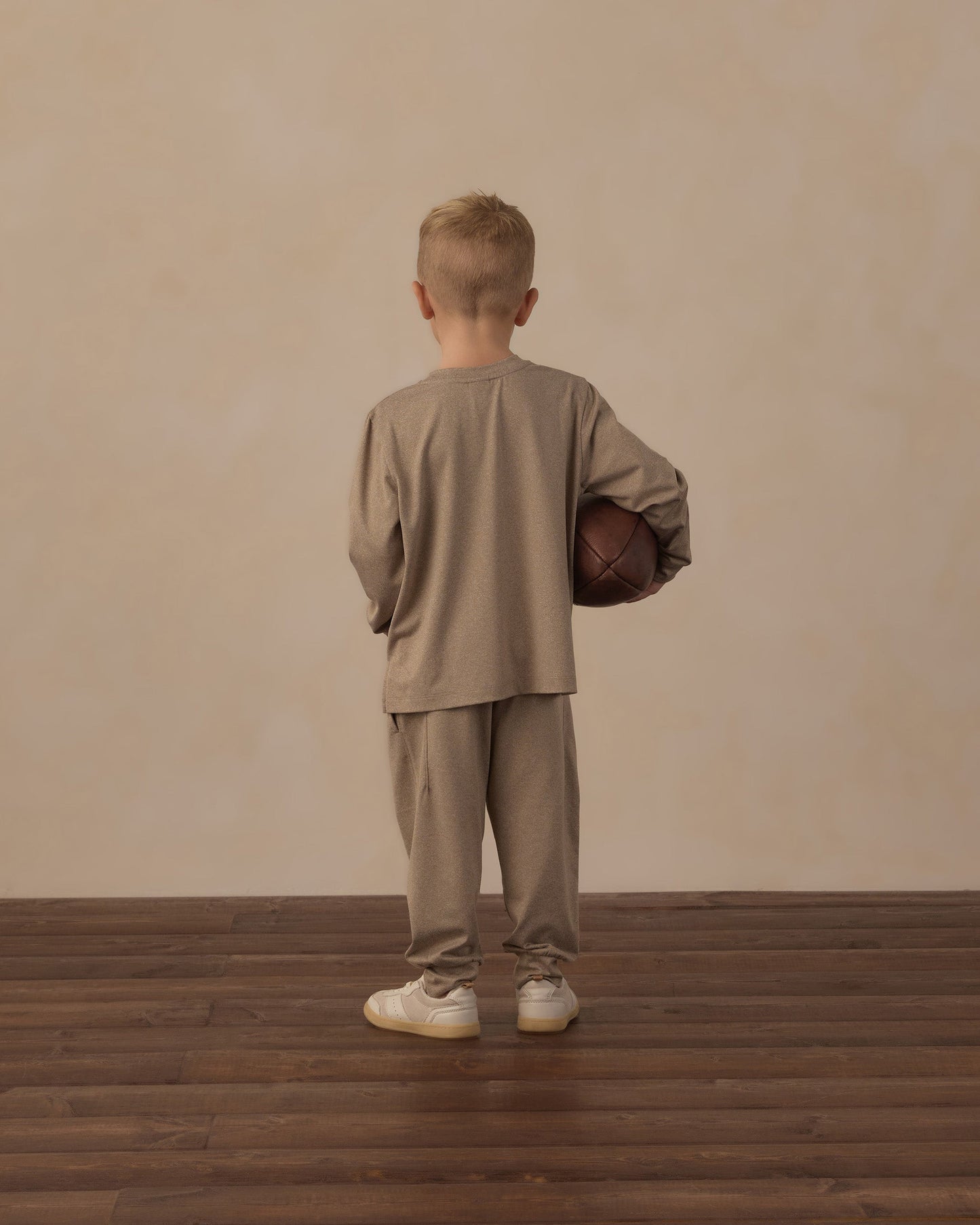 Child playing outdoors in the Heather Olive Tech Jogger