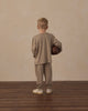 Child playing outdoors in the Heather Olive Tech Jogger