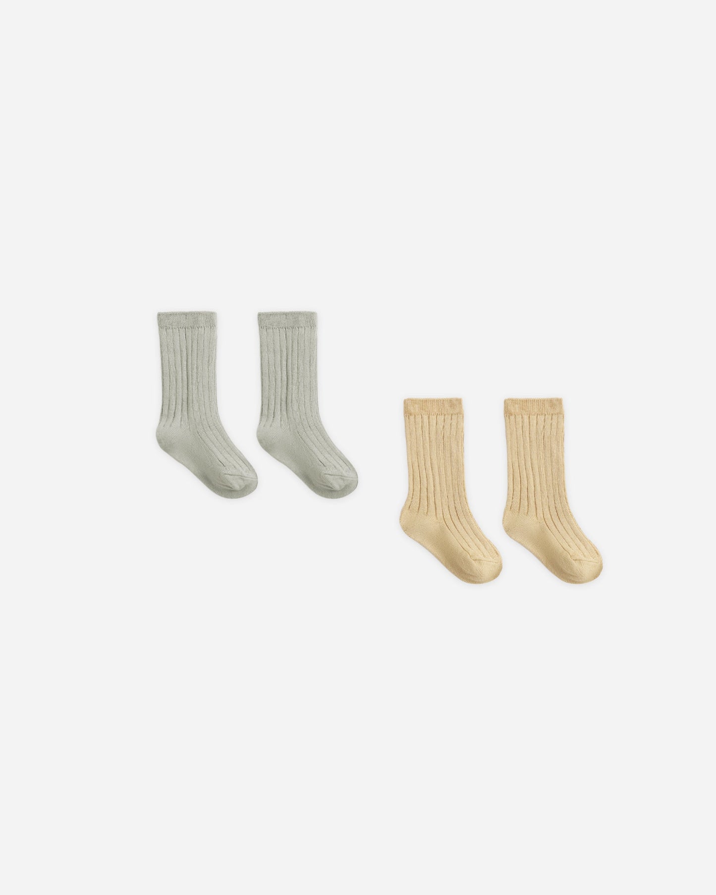 Baby wearing Quincy Mae Laurel and Butterscotch socks set