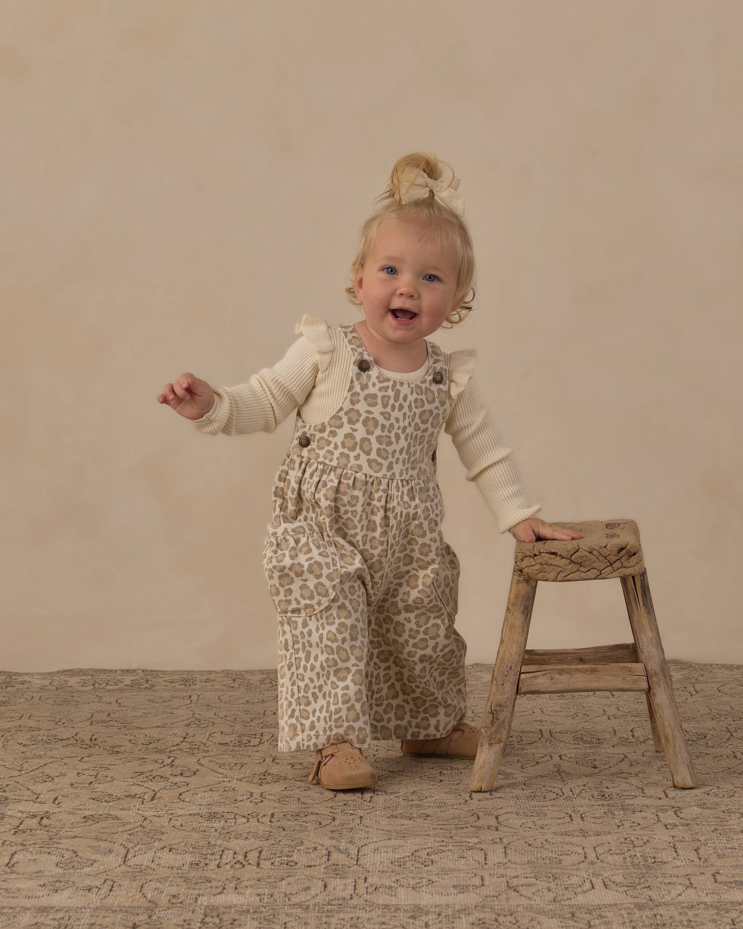 Close up of the leopard print and brass buttons on the overalls