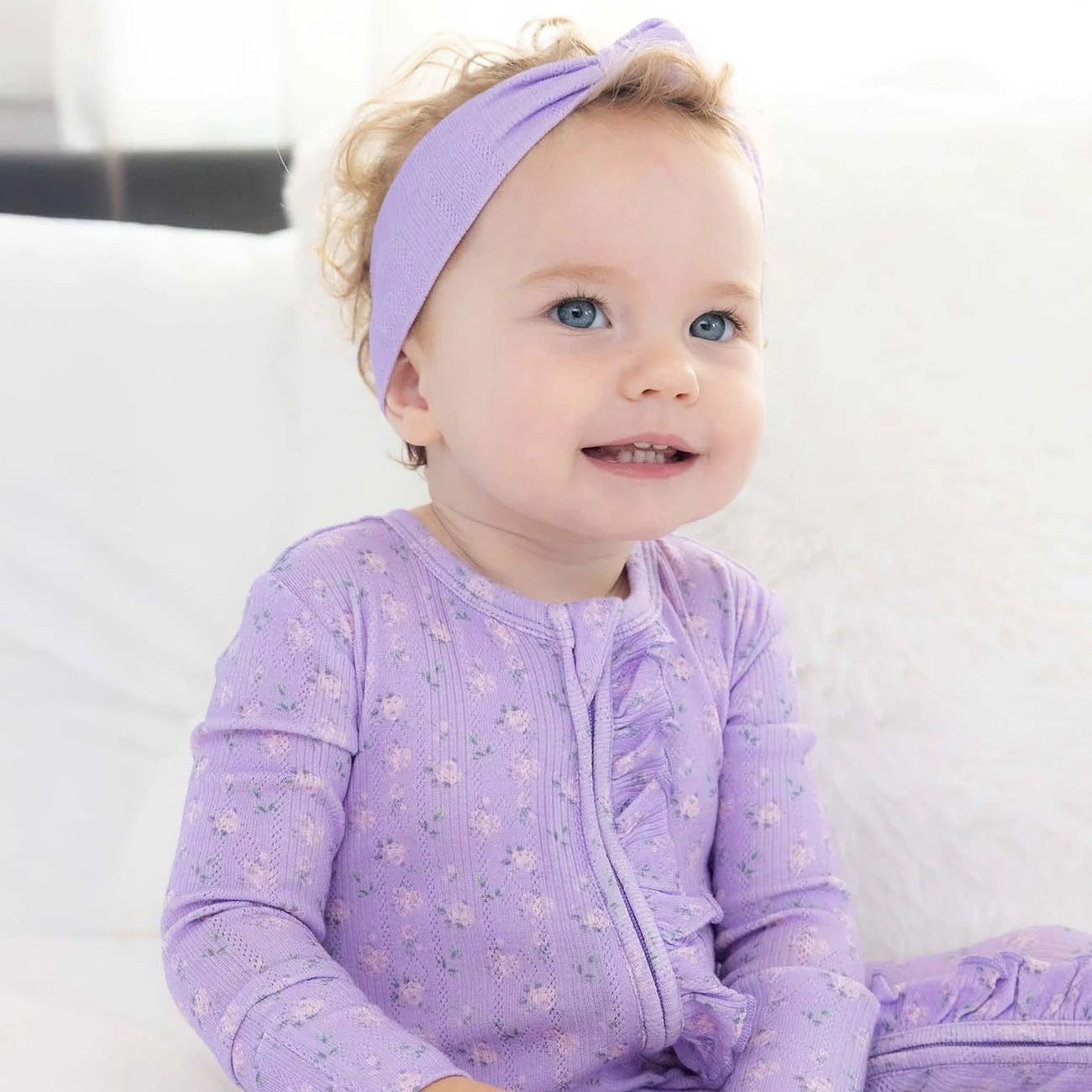 Purple ruffle footie with pink flower all over print