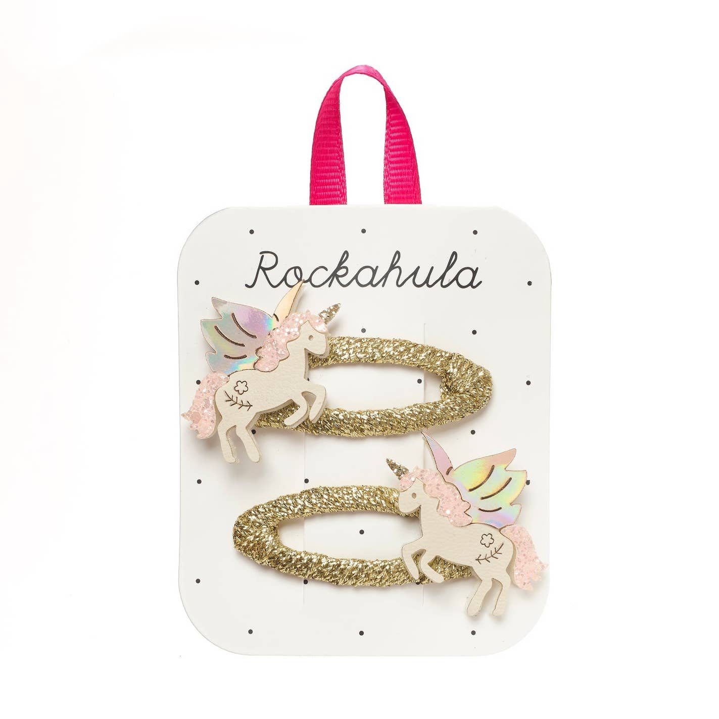 A set of two gold glitter hair ties with pastel unicorn charms, presented on a white display card with a pink ribbon loop and the brand name 'Rockahula'.