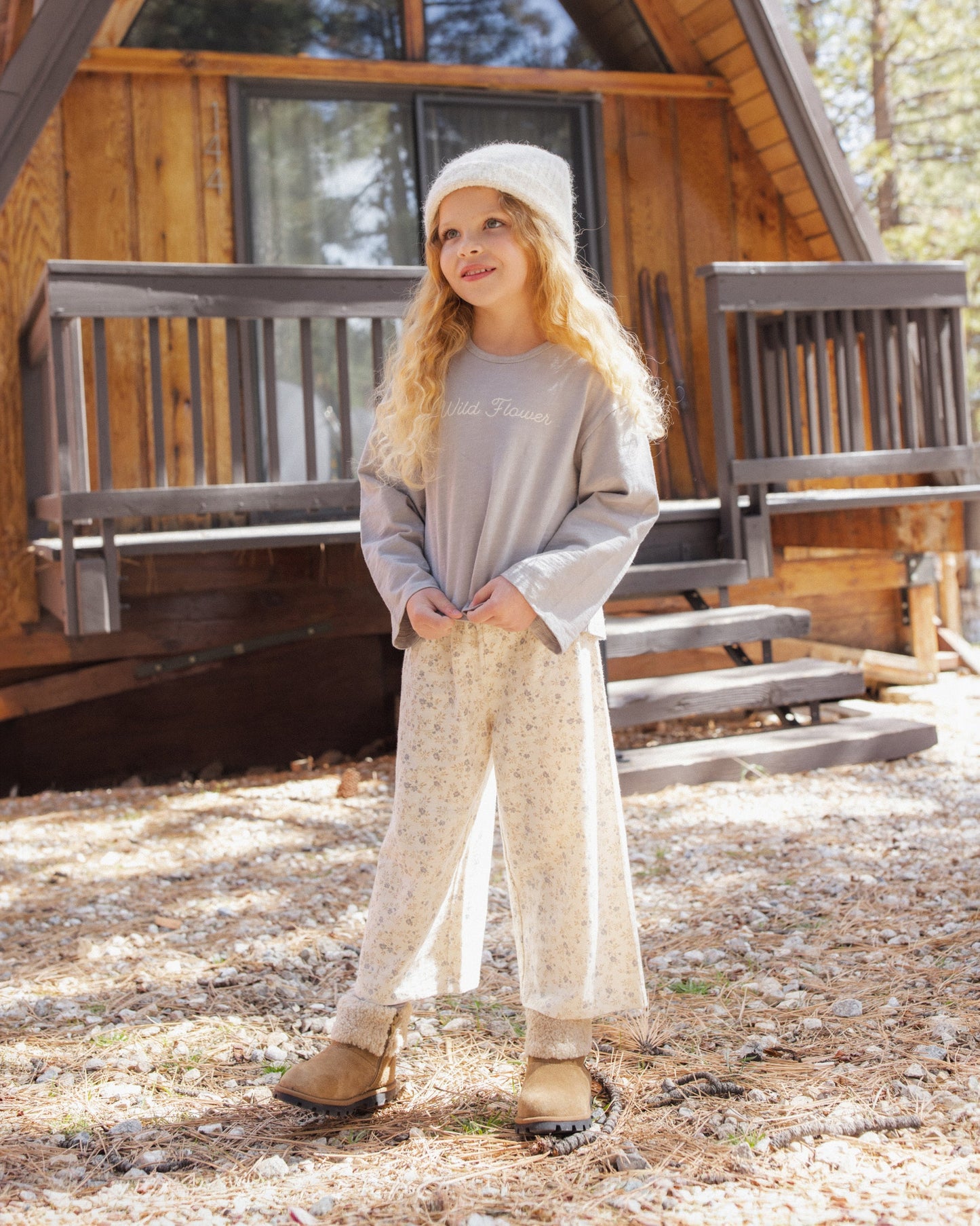 Girl standing in the wide leg Meadow print pants